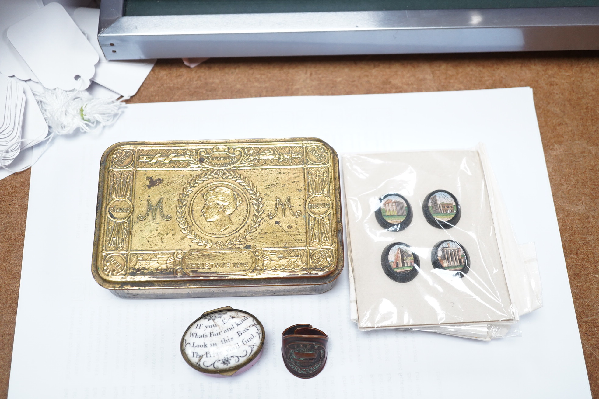 An 18th century enamel patch box with motto and four Italian Grand tour style micro-mosaic panels, housed in a 1914 Christmas tin. Condition - fair